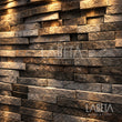 Muro de Cintilla de San Andrés con iluminación dramática que resalta su relieve — ambientación digital sobre instalación real | Piedras Labeta
